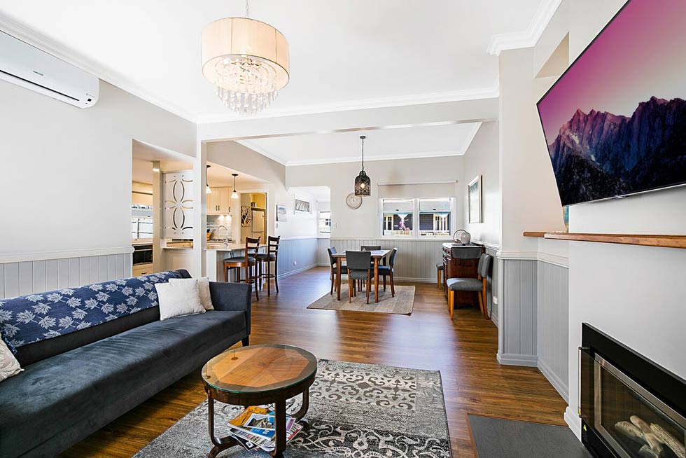 Open plan style integrates the kitchen with separate dining and lounge areas.