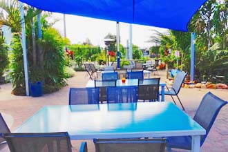 Yasi Bar + Grill features a poolside dining area with children’s playground - Cardwell @ the Beach Cardwell QLD